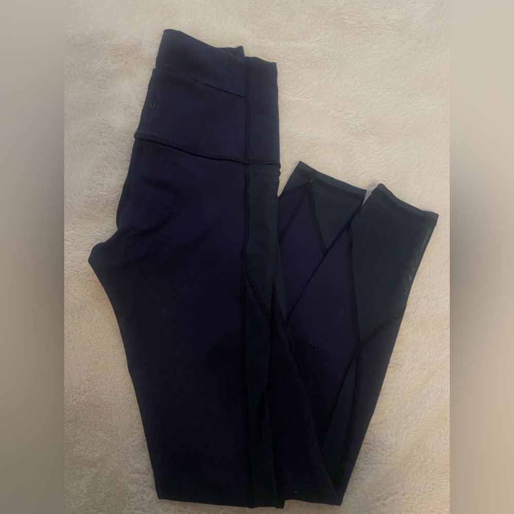 Lululemon navy blue leggings. Lightly worn with mesh detail and pockets.